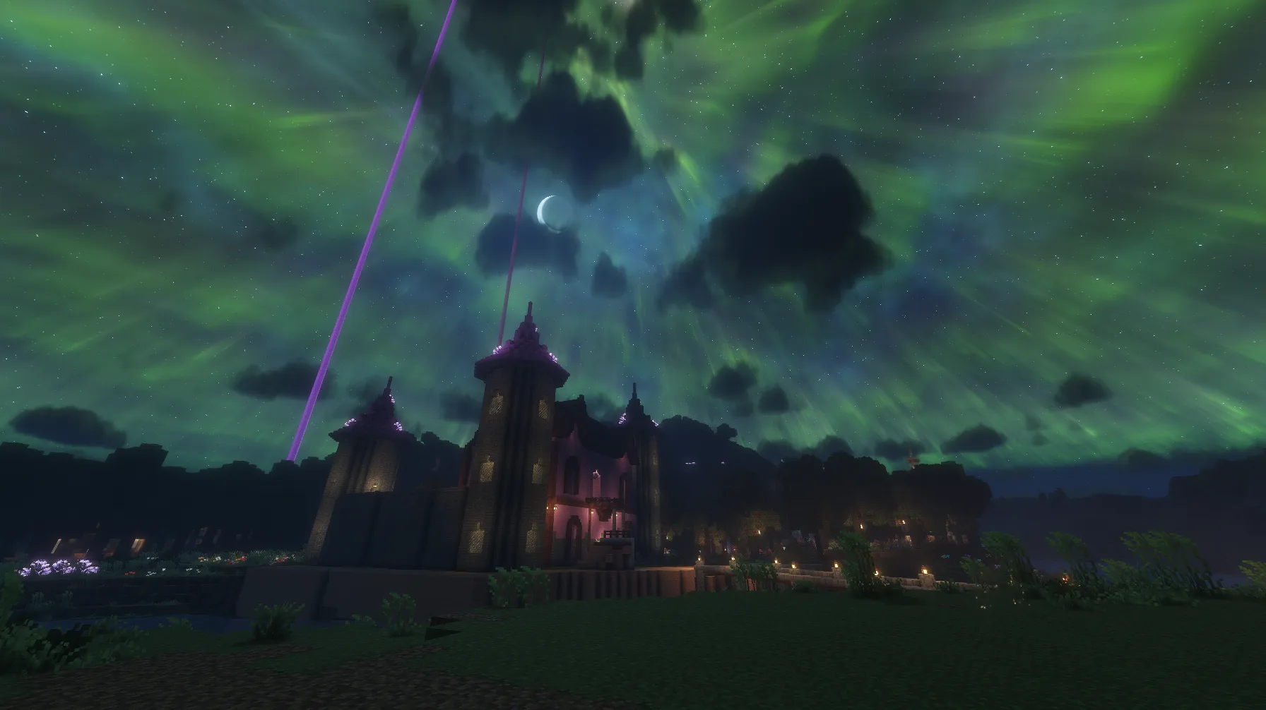 Green northern lights sweep above kaestar’s illuminated castle and gardens beneath a crescent moon.