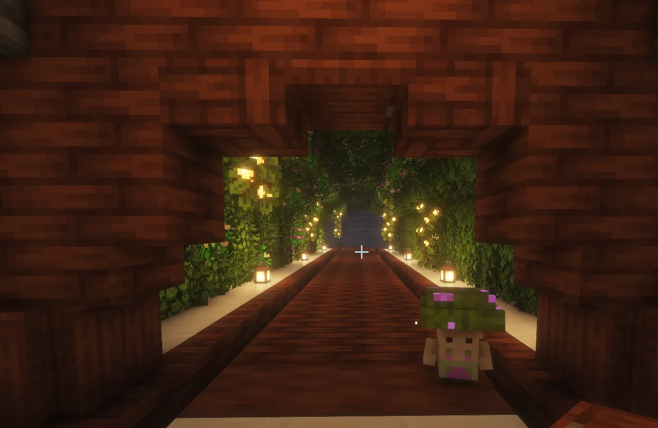 A pink-capped mushling stands at the mouth of a lantern-lit leafy tunnel.