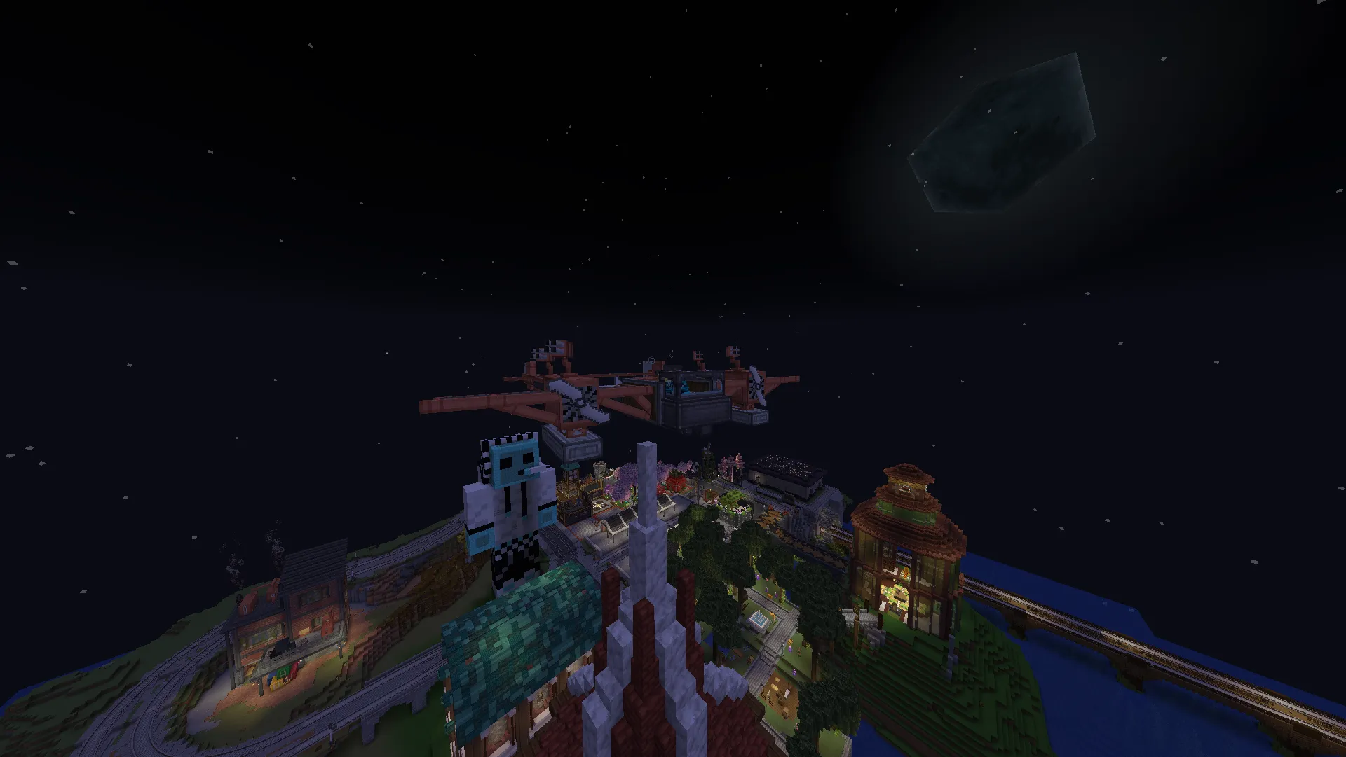 An airplane flies above Homestead’s lit rooftops at night, seen from a tall teal-and-white tower.