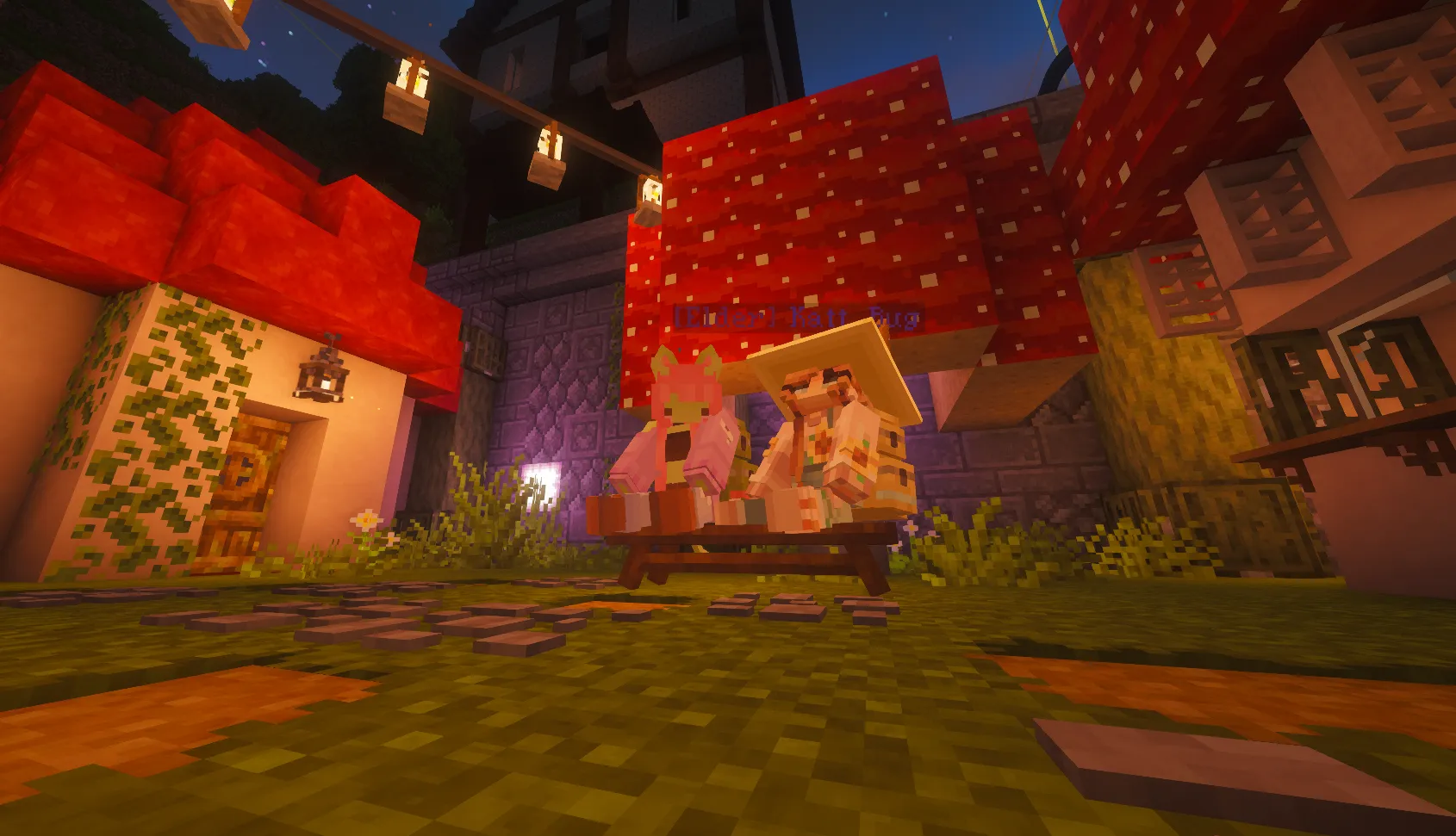 Two Minecraft characters sit on a bench beneath a giant red mushroom, surrounded by lanterns, flowers, and warmly lit buildings at night.