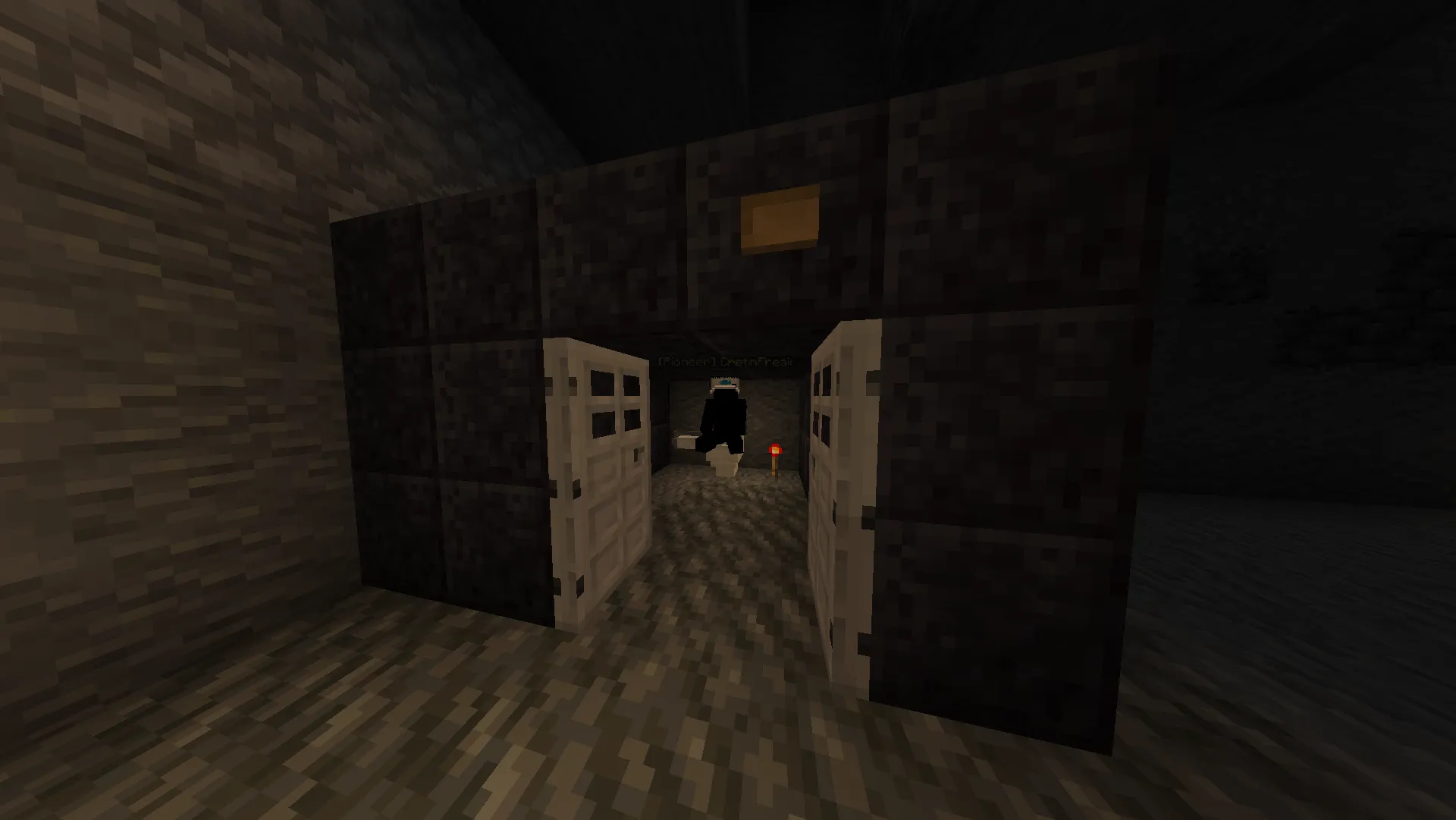A player stands beyond open iron doors at the dark stone entrance to gingerlmao's underground club.
