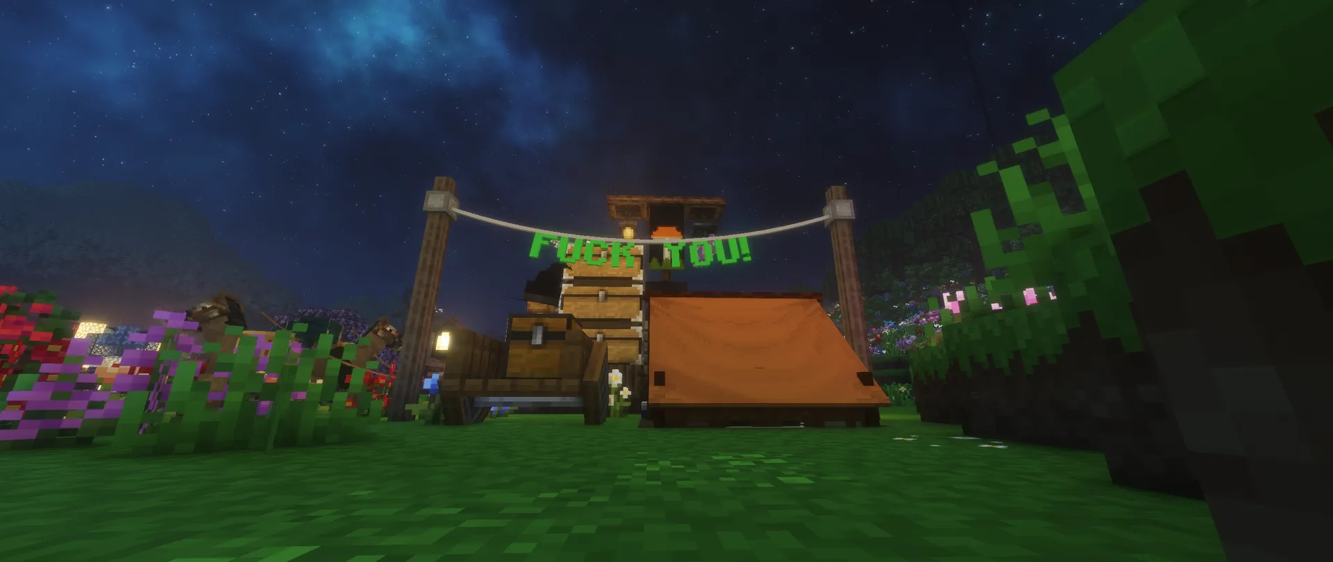 An orange tent, stacked chests and flowers beneath a starry sky, with a green banner reading “FUCK YOU!”